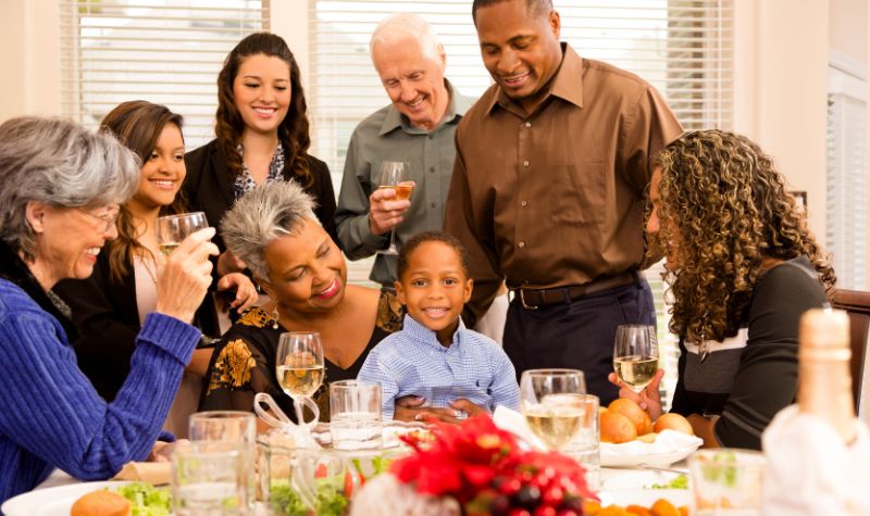 Multigenerational family celebrating the holidays at a dinner table.