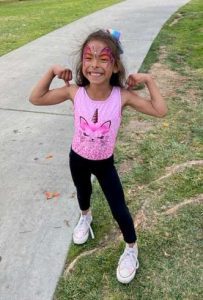 Olivia at the Long Beach Walk4Hearing flexing her arms