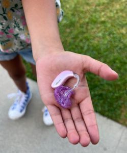 Olivia's pink hearing aids
