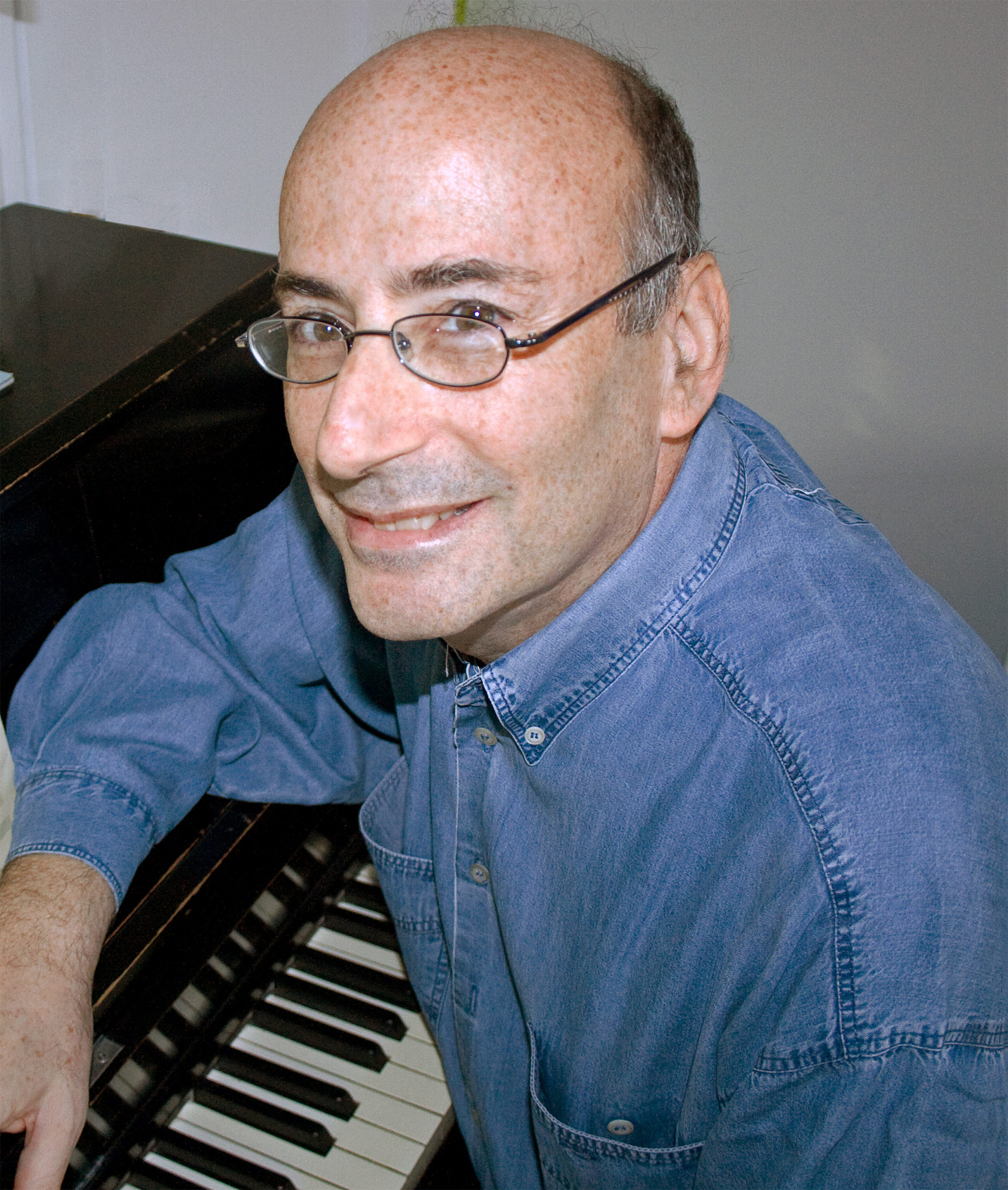 Richard Einhorn sitting by a piano
