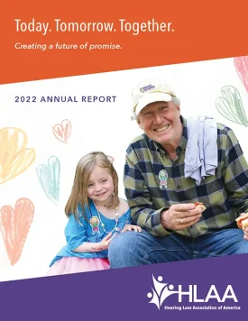 Grandfather and his granddaughter enjoying time together on the cover of the HLAA 2022 annual report