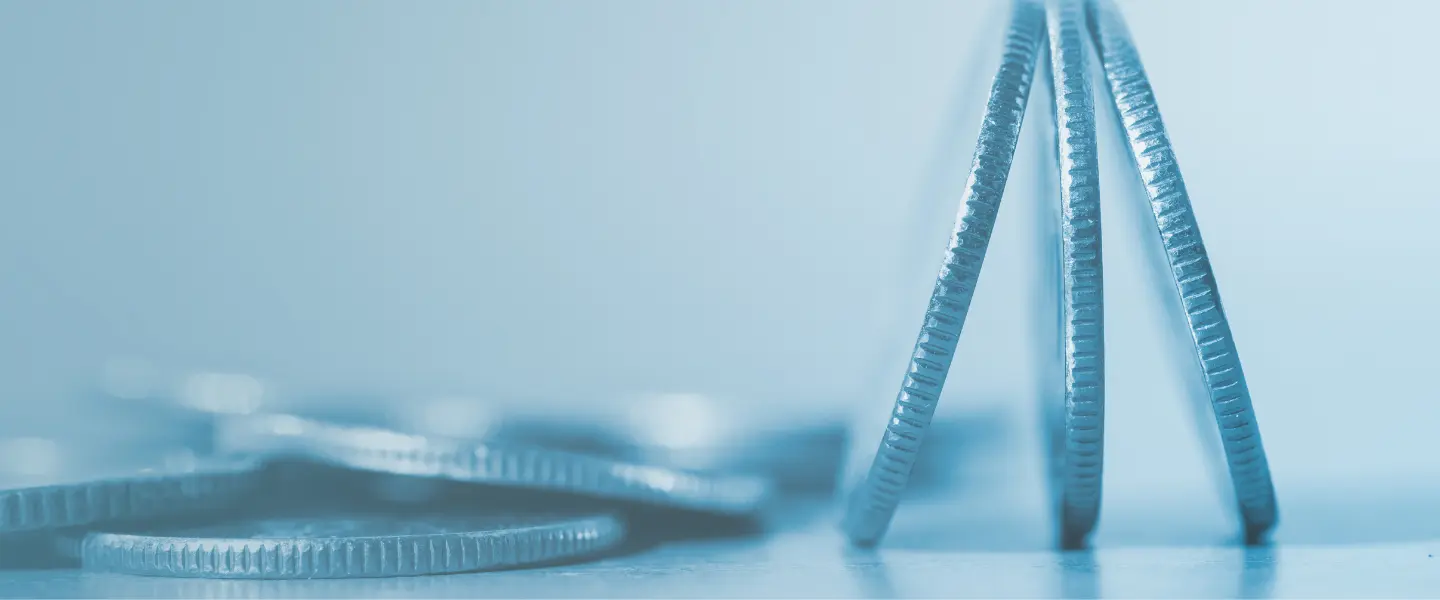 Close up of coins standing on end.