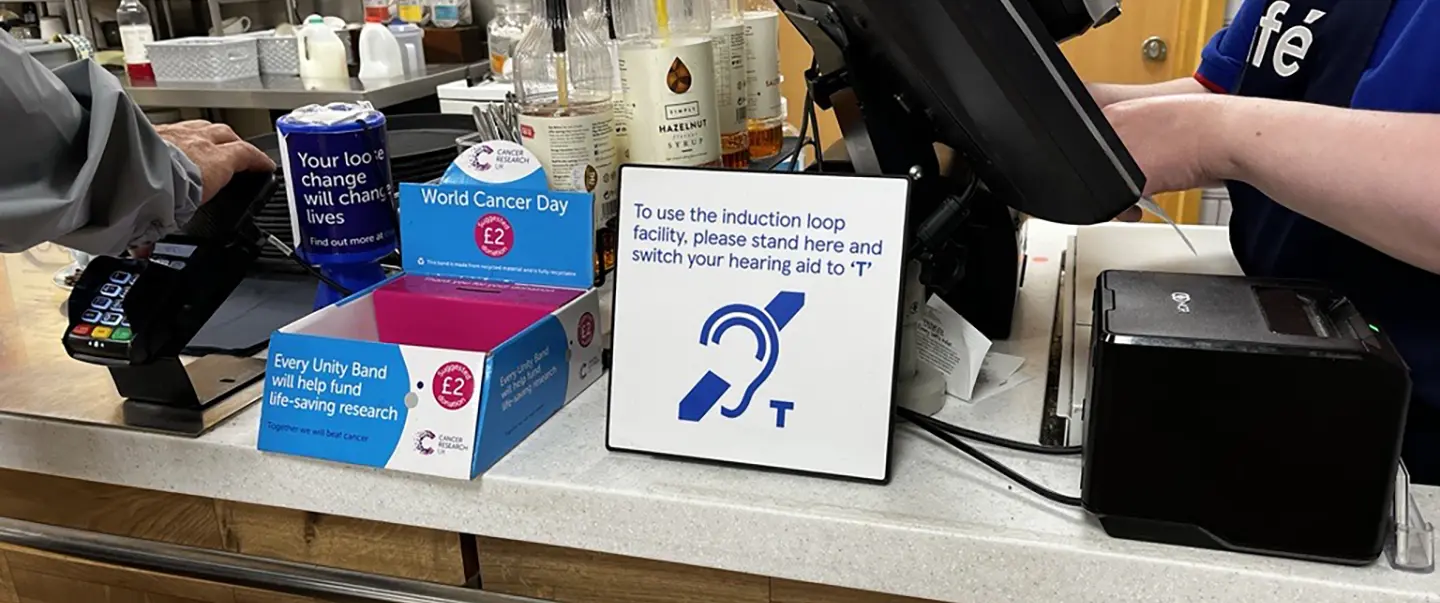 Store counter showing a hearing loop sign.
