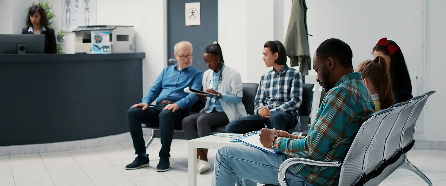 People sitting in a doctor's waiting area for their appointment.