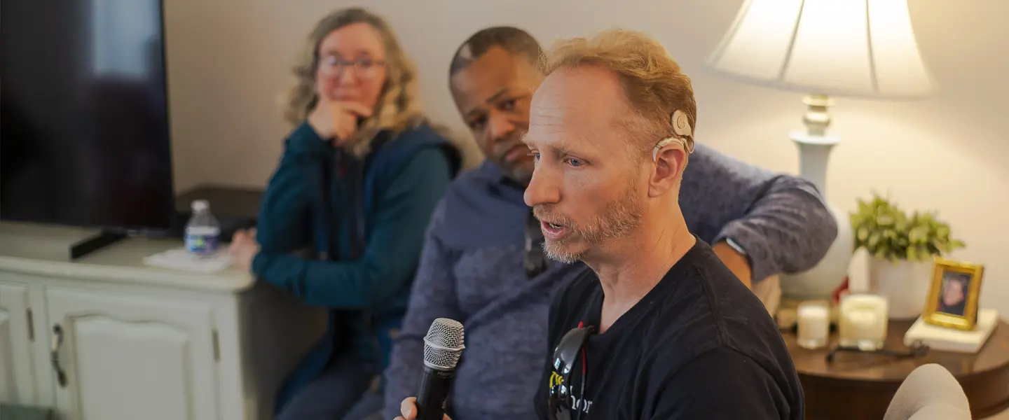 A man with a Cochlear Implant speaks to a support group.
