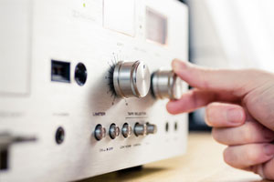 lower-the-volume A hand turning down the music volume