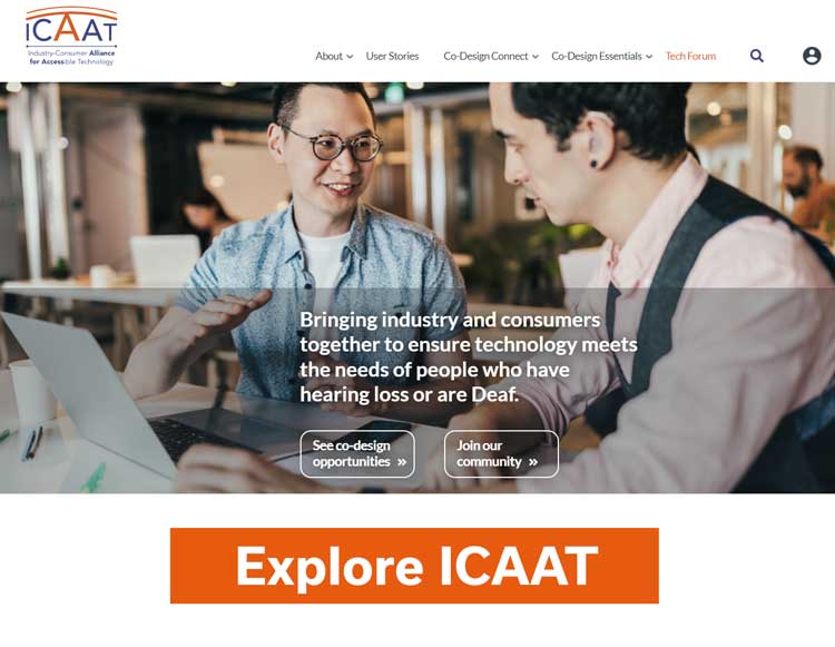 Two men with hearing loss talking at a table.