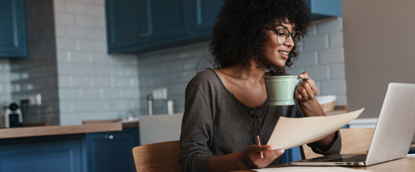 A young women reviewing information on her laptop