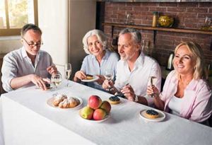 middle-of-table A group of people sitting along a table