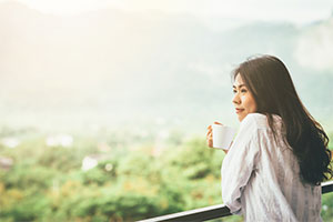 take-time-alone A woman looking over on a balcony