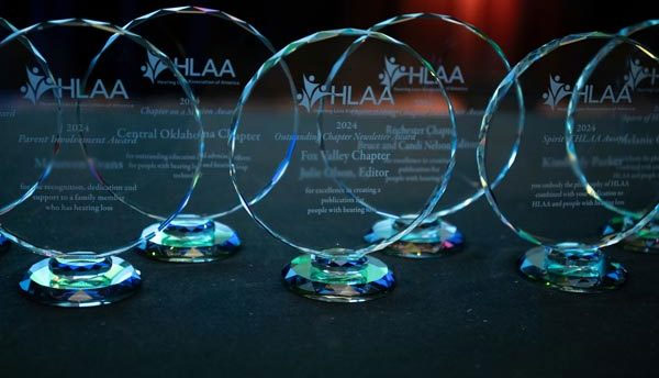 Close up display of past HLAA award winner trophies