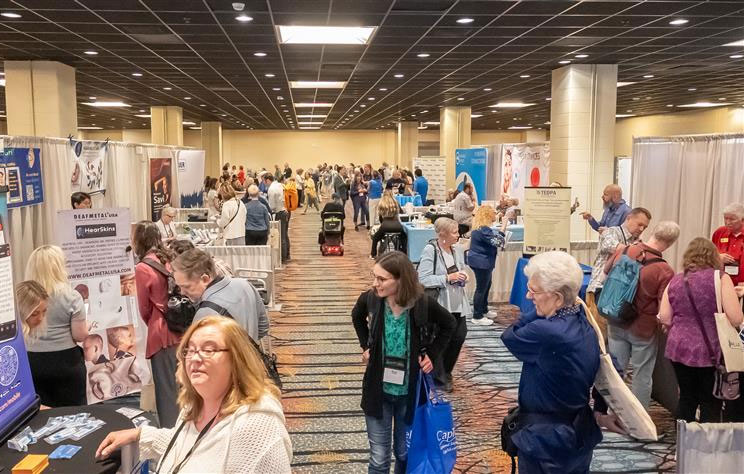 The exhibit hall from the Indianapolis 2025 convention filled with people at vender booths.