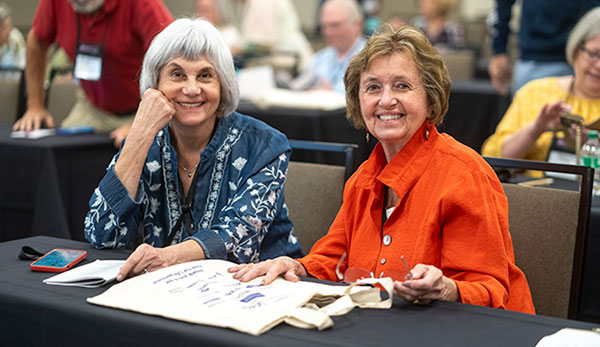 workshop-main-page Two women smiling before the start of an HLAA workshop