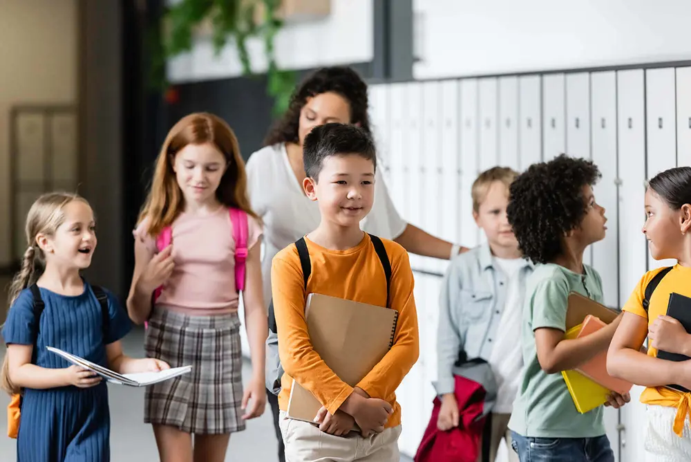 Group of diverse schoolchildren in front of lockers