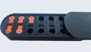 Hearing aid battery caddy with individual compartments.