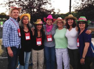 A group of seven HLAA members wearing cowboy hats at a conference