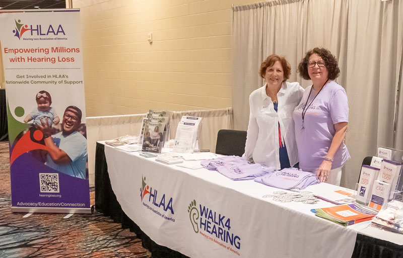 Teri Breier and Melissa Kruse tabling at the HLAA 2025 Convention