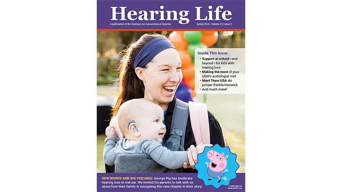 A young mother celebrating at a Walk4Hearing event with her baby son who is wearing a hearing aid.