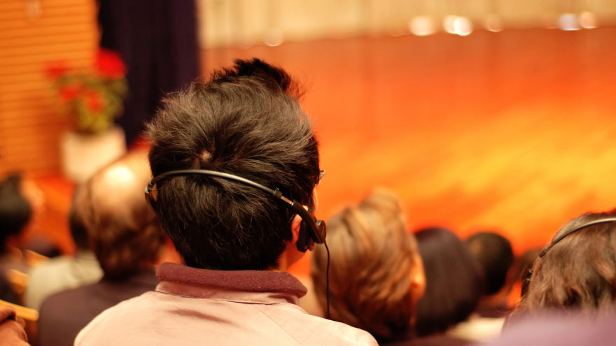 A man wearing headphones during a presentation